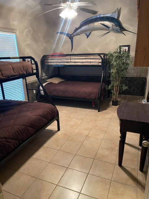 Room with bunk beds, tiled floor, and decorative fish on the wall Venice Louisiana